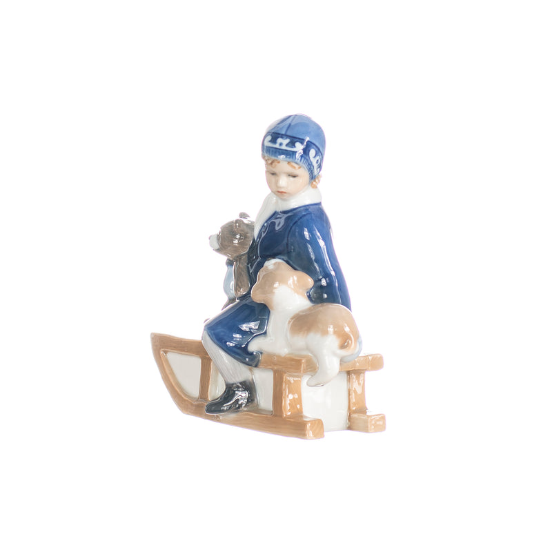 little girl figurine on sleigh in hand decorated porcelain
