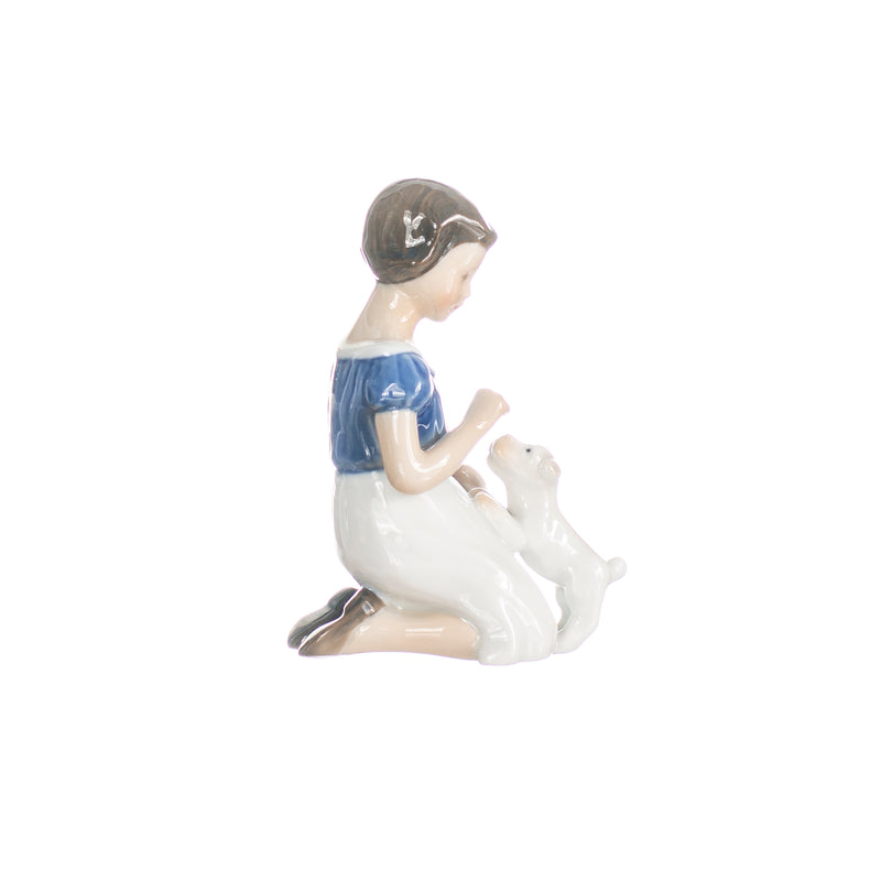 little girl with puppy figurine in hand decorated porcelain