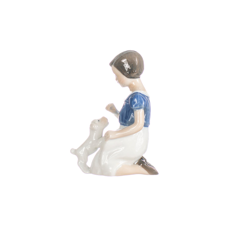 little girl with puppy figurine in hand decorated porcelain